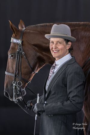 Elegant portrait of an equestrian with a brown horse against a dark backdrop. Sonya Helm Equine Photography, Bristol, TN
