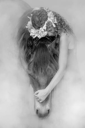 Black and white art photos show a melancholic figure with hair adorned in delicate lace against a soft, ethereal backdrop.