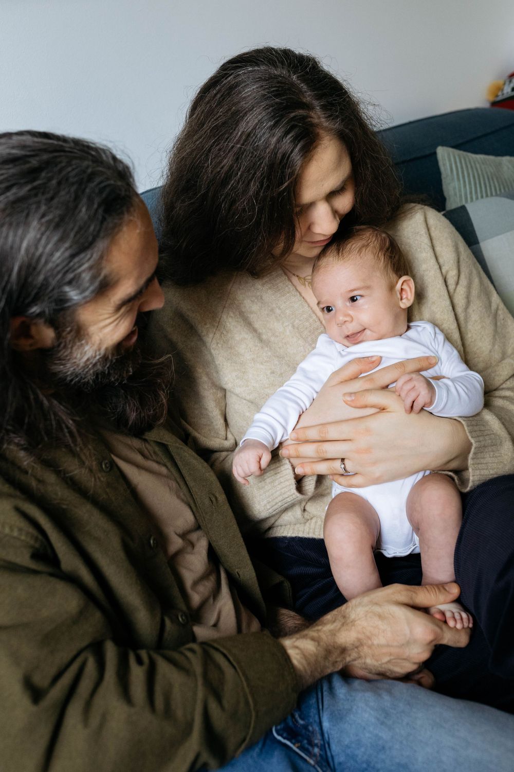 mum holding two month old baby on her lap
