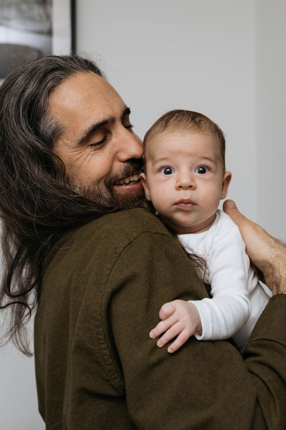 two month old baby boy being held by his dad