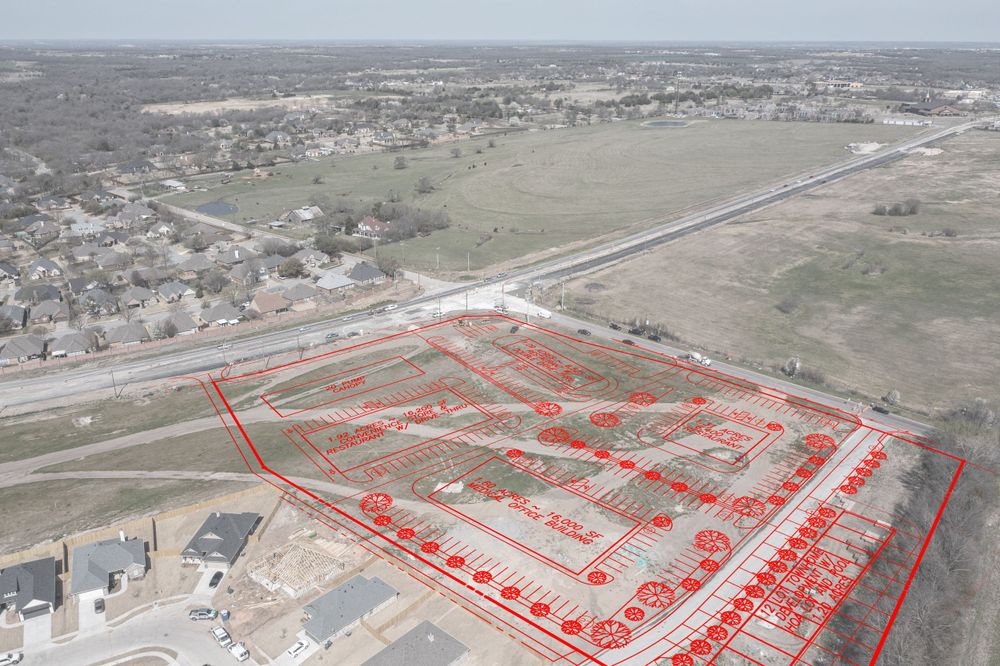 Aerial view of property boundaries marked in red lines overlaying a suburban development area.