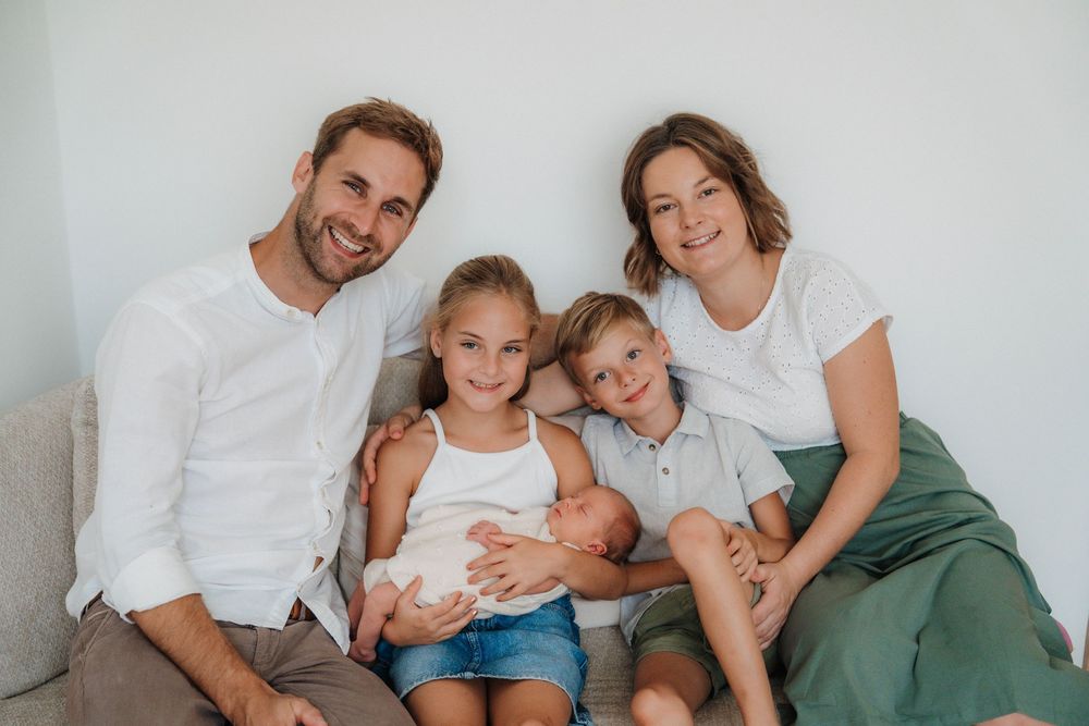 Family portrait series showing tender moments together against a light background.