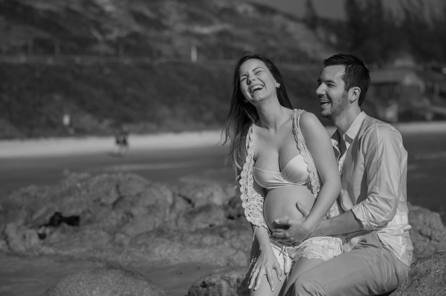 A joyful moment captured in black and white on a scenic overlook.