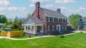Row of residential houses with diverse architectural styles along a suburban street.