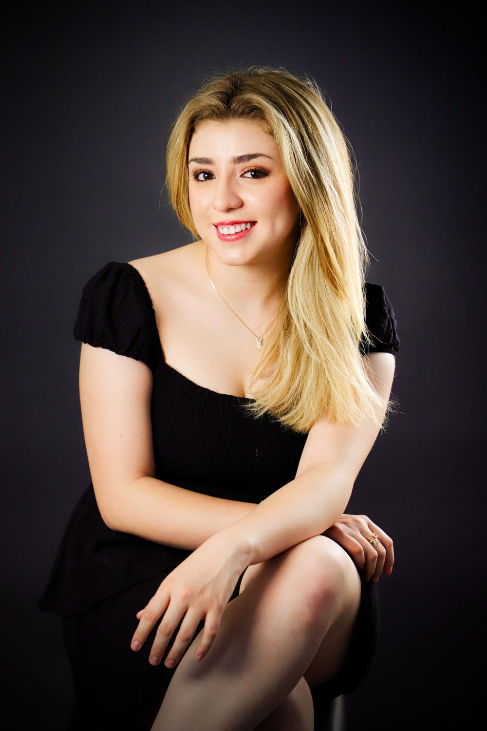 Dramatic portrait photography against dark background with artistic lighting.