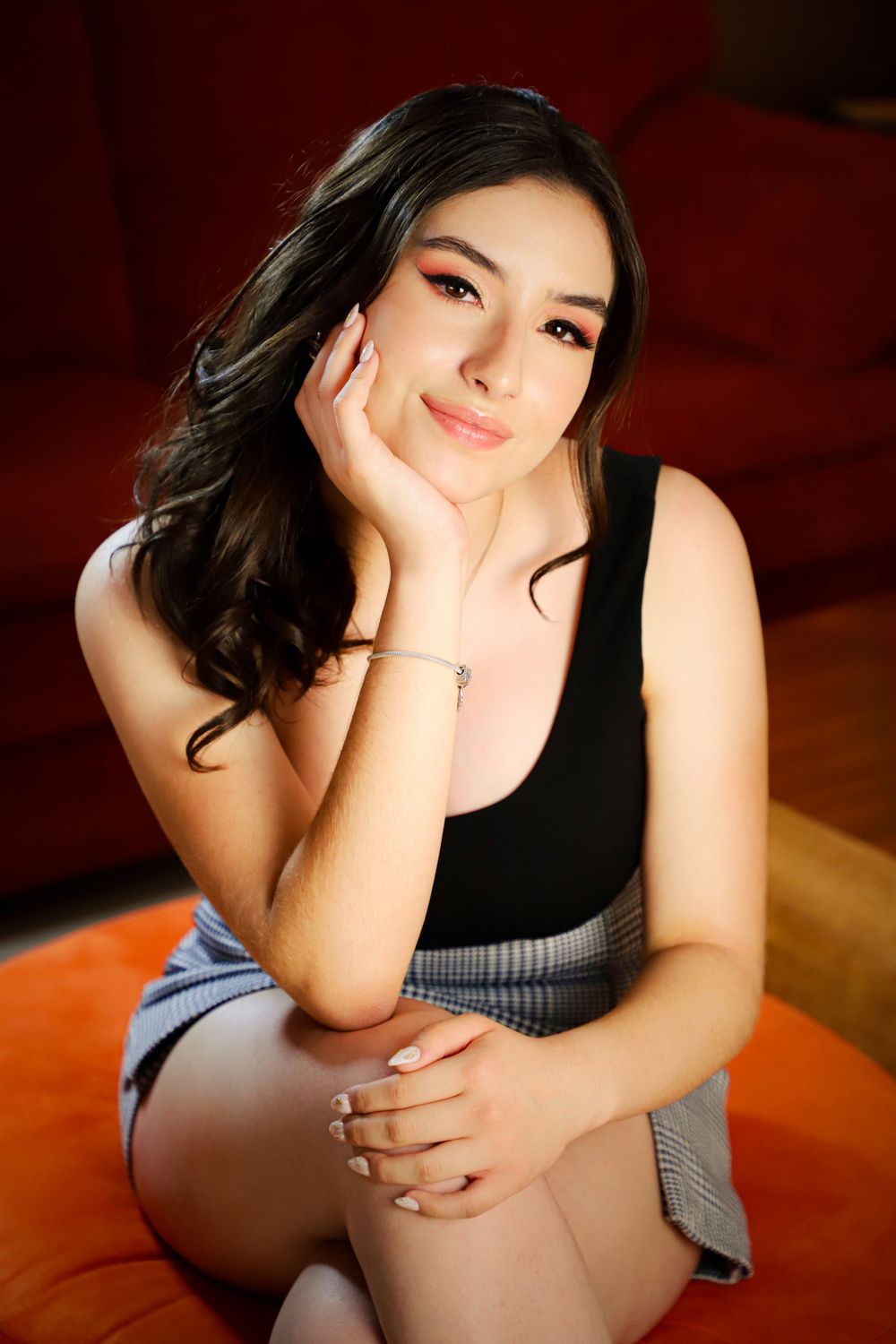 Casual portrait session with black top and checkered pattern.