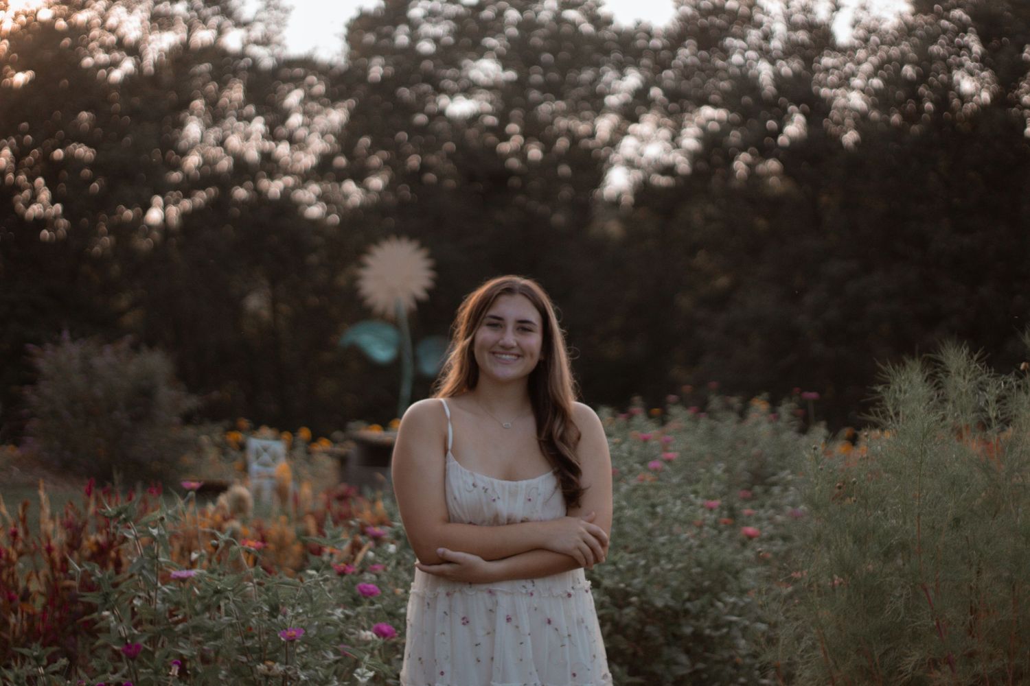Sunset photoshoot in a wildflower field filled with vibrant red blooms.