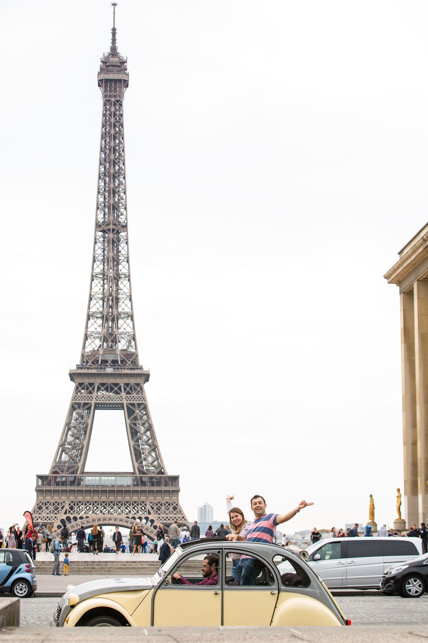 Professional family vacation photos in Paris by Picmytrip Paris. With a vintage car typical french, Full Eiffel tower view