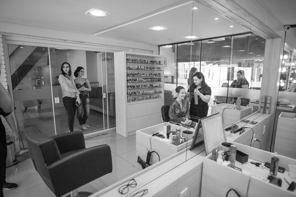 Interior view of a beauty salon with mirrors and styling stations.