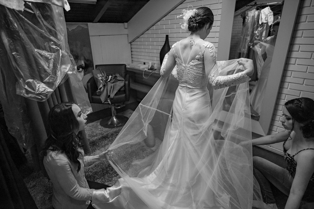 Wedding dress fitting session showing the back detail of an elegant white gown.