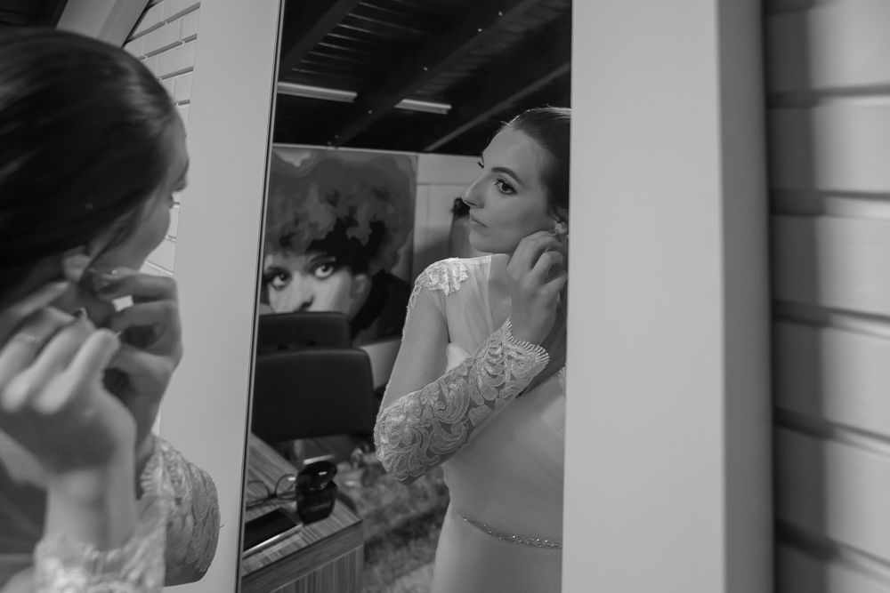 Artistic reflection shot of bridal preparations in a mirror.