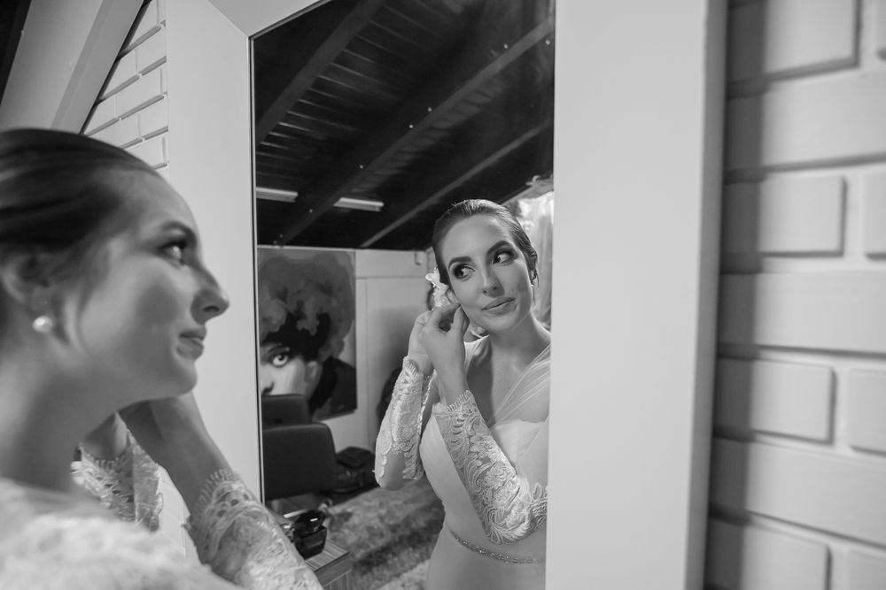 Side profile reflection of bridal preparations in a mirror.