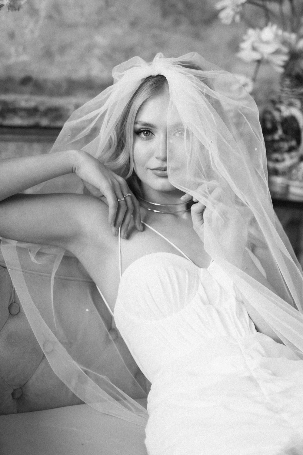 Artistic black and white bridal portrait with flowing veil.