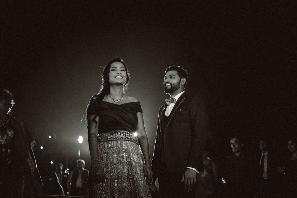 Dramatic black and white nighttime reception scene with moody lighting.