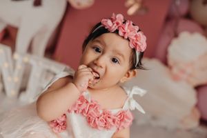 Pink floral themed birthday party setup with roses and pastel decorations.
