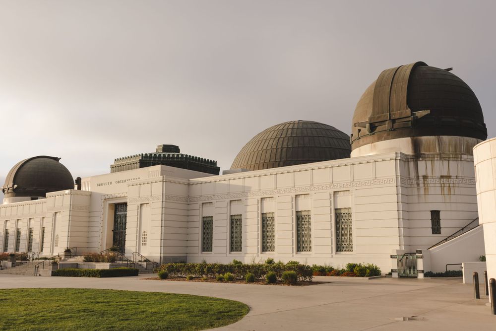 The historic Griffith Observatory with its multiple domes against an overcast sky.