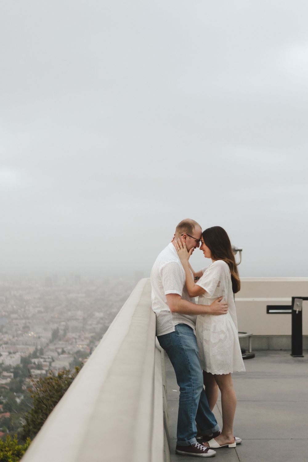 An intimate embrace against the Los Angeles skyline at Griffith Observatory.