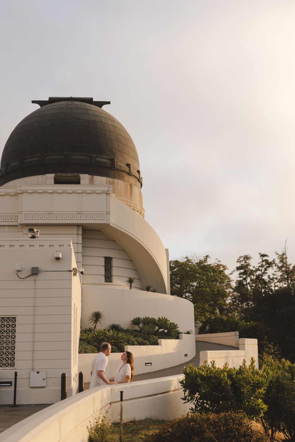 View of the Griffith Observatory dome and architecture against a cloudy sky.