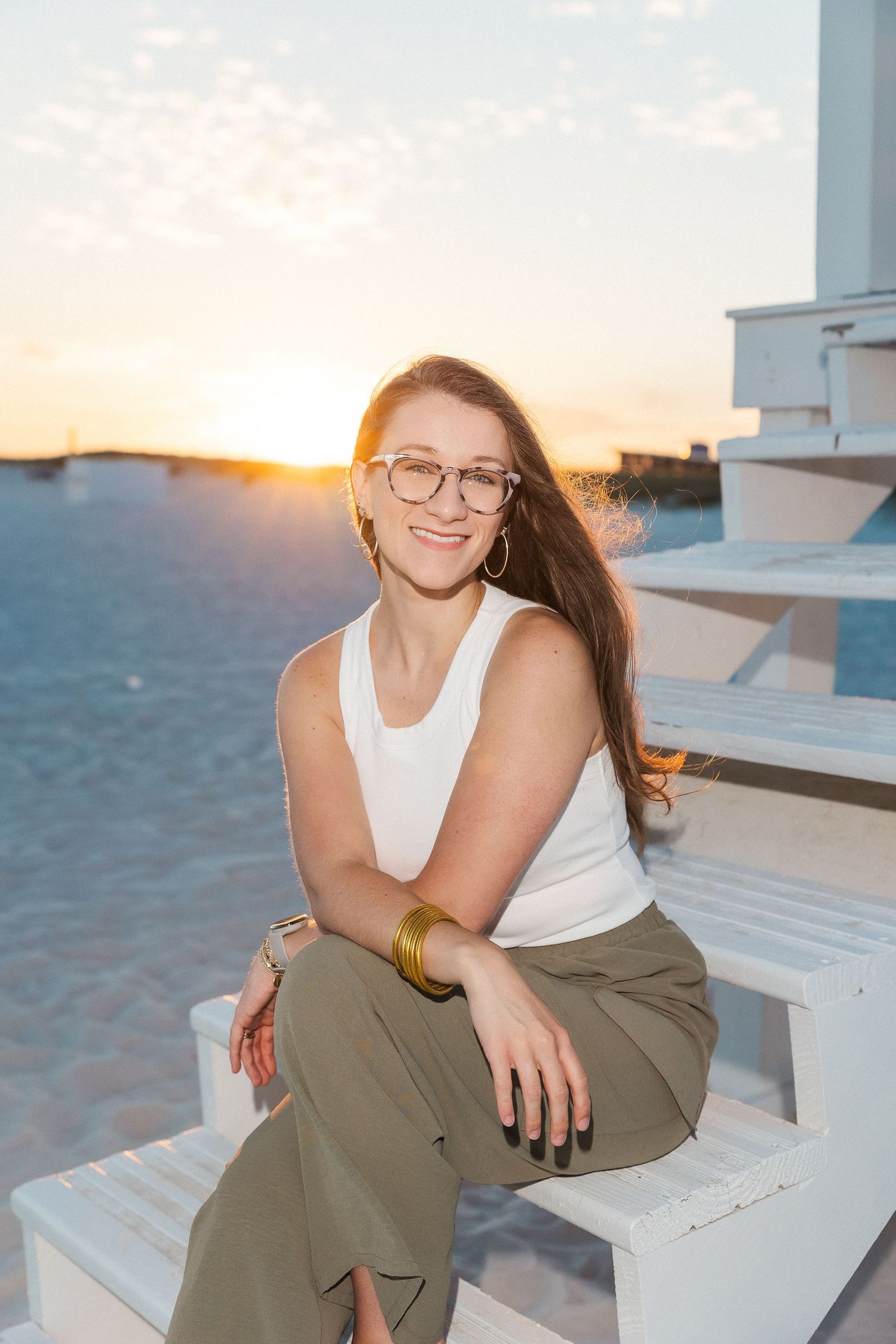 Professional headshot portraits with glasses and natural lighting against a white background.