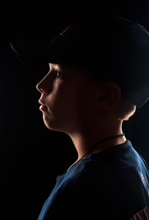 Dramatic silhouette portrait series showing a figure in a hat against dark background with moody lighting.