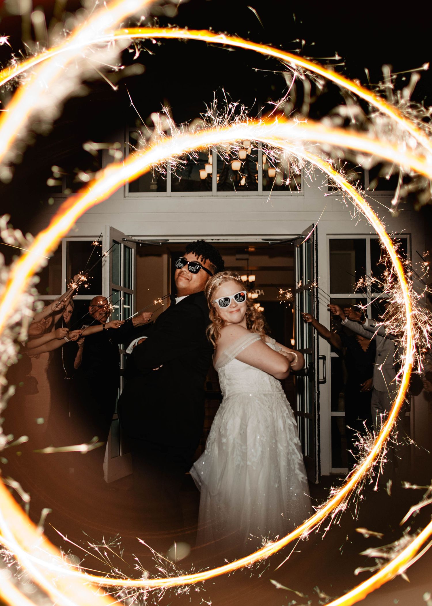Brianna & Joan Germosan posing in sunglasses at their wedding sendoff at Lake Mary Events Center. Cred: LexTakePix