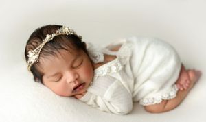 Indian newborn wearing a cream lace outfit on her belly with her bum up. - Greenville SC newborn photographer - Easley SC newborn photograph