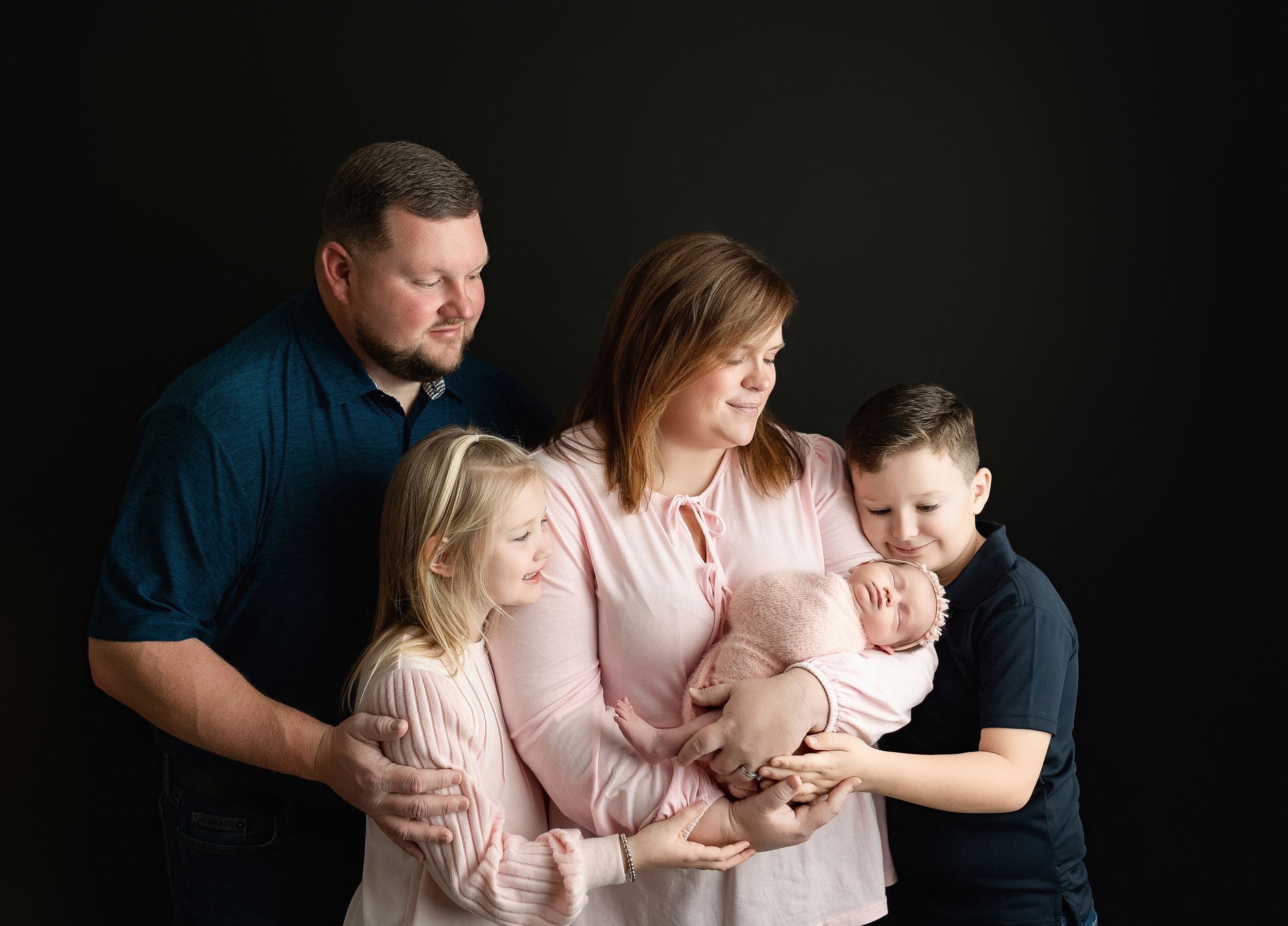 Large family holding newborn showing their connection. Greenville SC newborn photographer. - Easley Sc newborn photographer. Greenville SC p