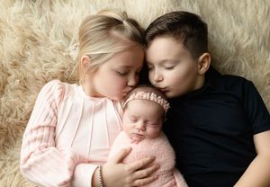 Siblings are holding their newborn baby sister. Greenville SC newborn photographer. - Easley Sc newborn photographer. Greenville SC photos