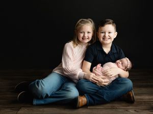 Sweet siblings holding their newborn sister on their lap. Greenville SC newborn photographer. - Easley Sc newborn photographer. Greenville S