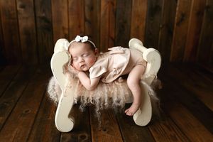 Newborn girl on her belly with her leg hanging. Greenville SC newborn photographer. - Easley Sc newborn photographer. Greenville SC photos