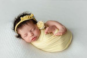 Newborn girl with a head full of hair wearing yellow. Greenville SC newborn photographer. - Easley Sc newborn photographer. Greenville SC ph