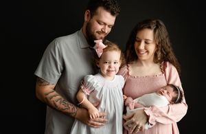A sweet family looking at big sis while holding their newborn. Greenville SC newborn photographer. - Easley Sc newborn photographer. Greenvi