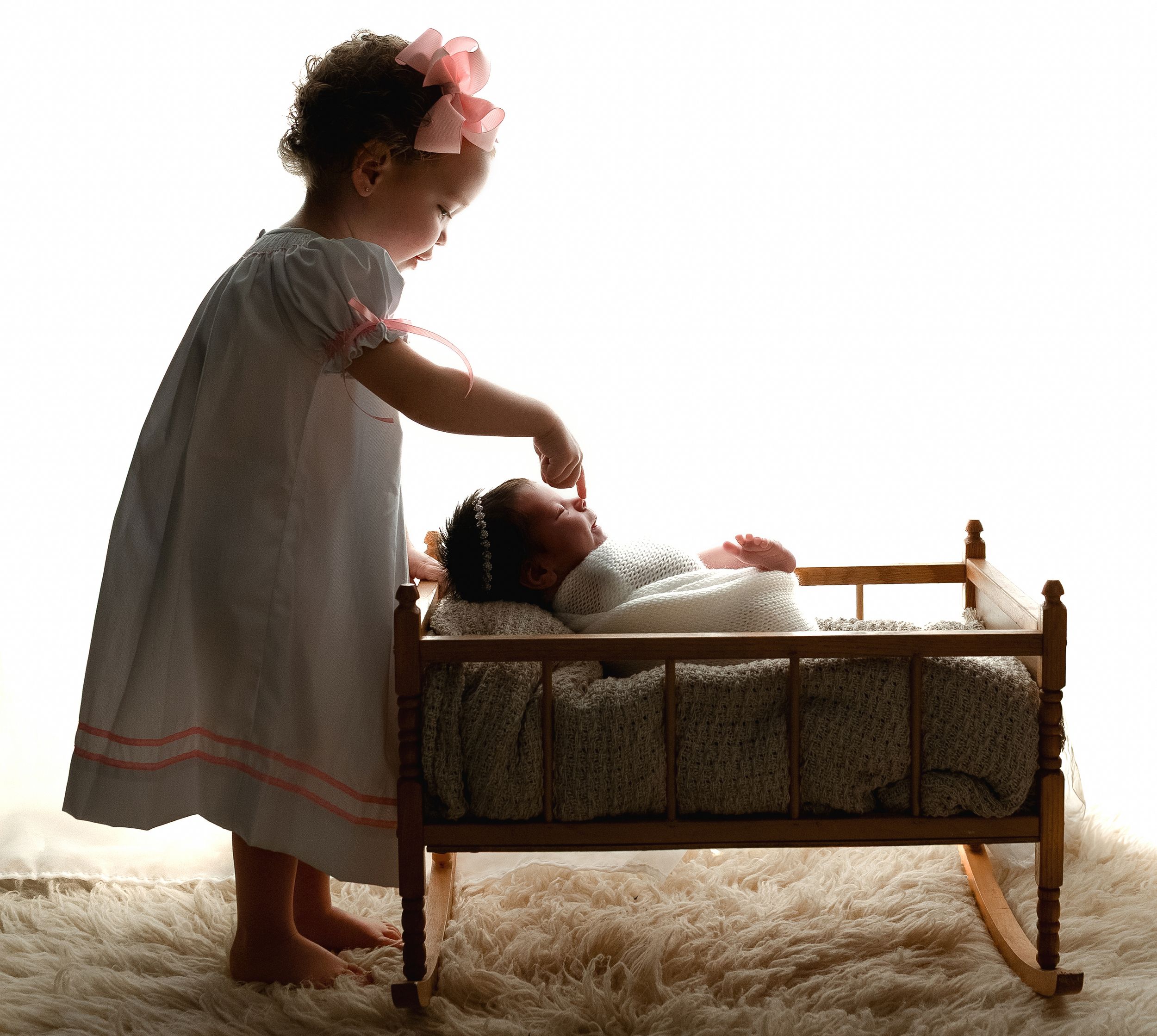 Big sister touching newborn girl's nose. - Greenville SC newborn photographer. - Easley Sc newborn photographer. Greenville SC photos