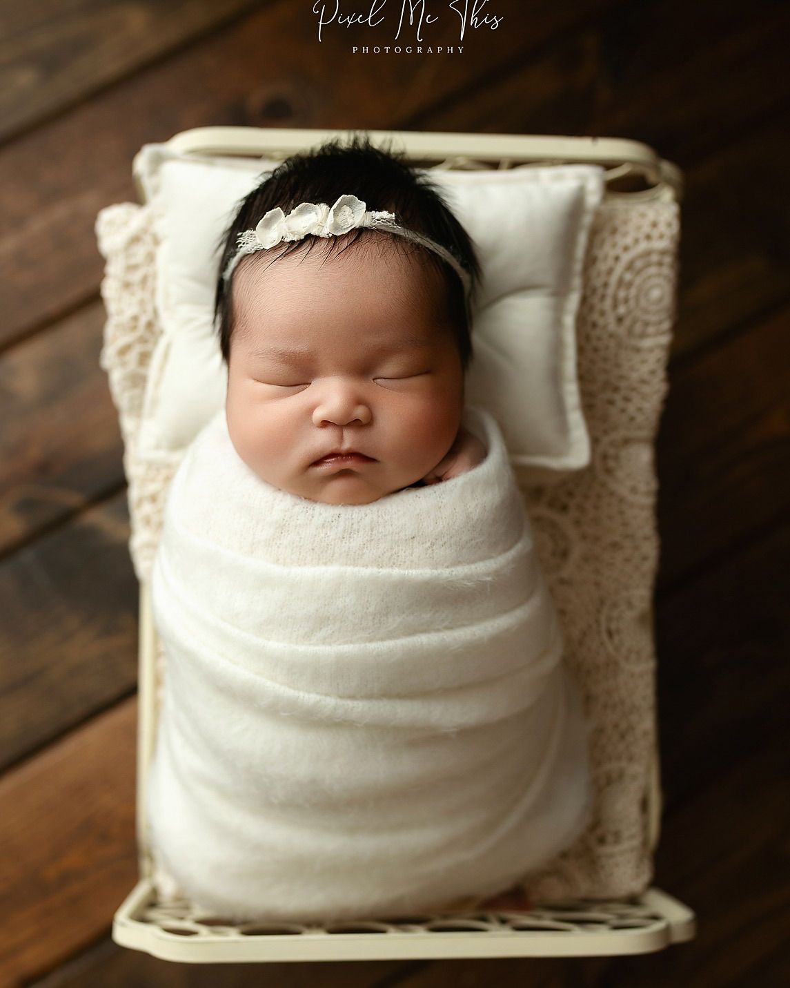 An Asian newborn baby girl in a cream bed. Greenville SC newborn photographer. - Easley Sc newborn photographer. Greenville SC photos