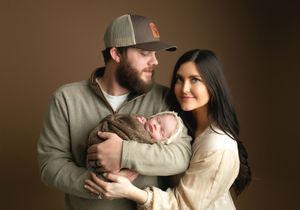 Family holding their newborn and mom looking back at me. Greenville SC newborn photographer. - Easley Sc newborn photographer. Greenville SC