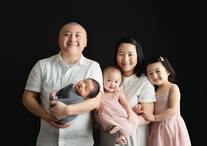 An Asian family holding their newborn baby boy. Greenville SC newborn photographer. - Easley Sc newborn photographer. Greenville SC photos