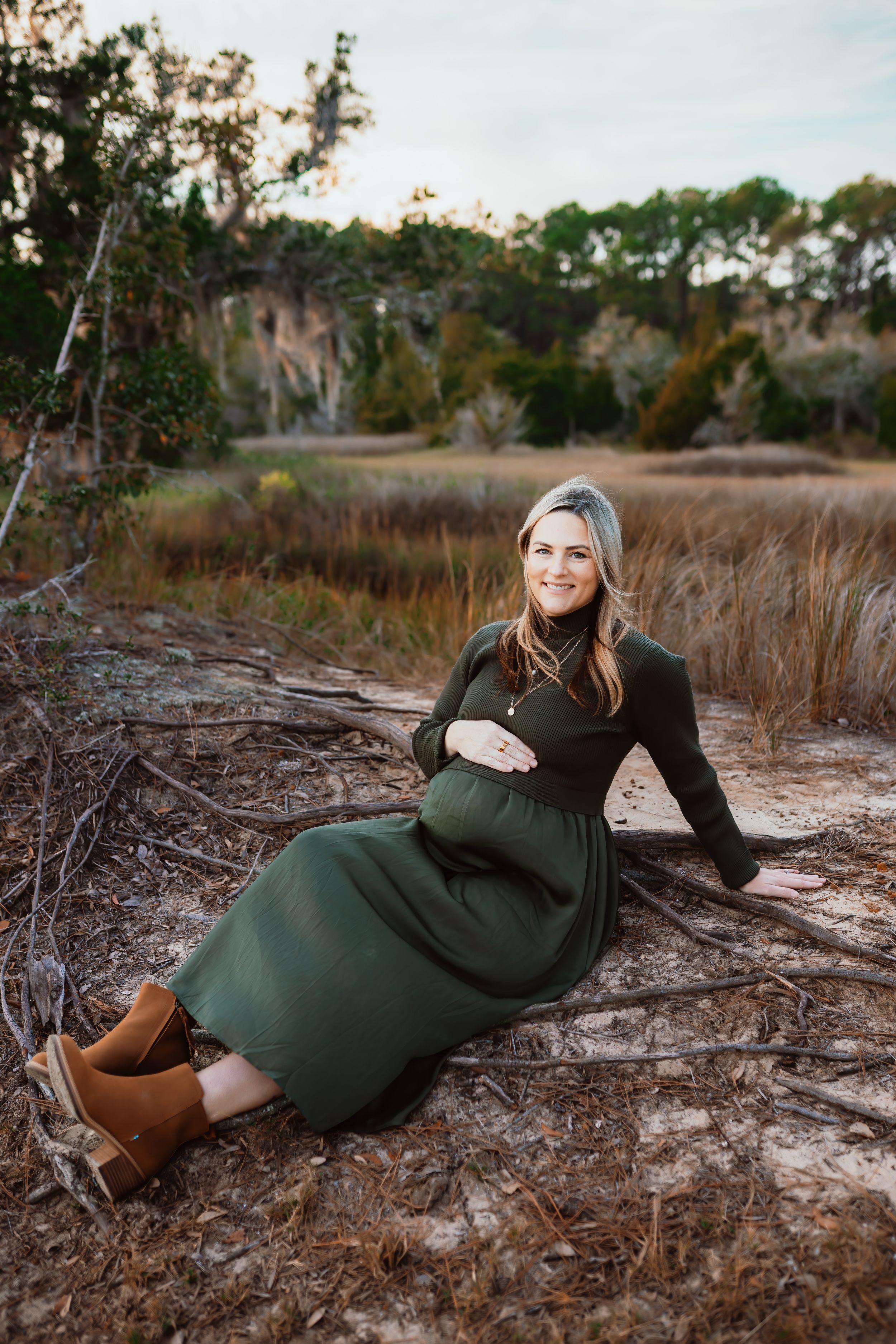 Motherhood, maternity, sitting down, marshside, sunset