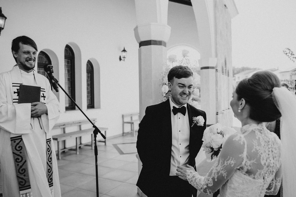 A series of black and white wedding photos showing intimate moments between couples during their celebration.