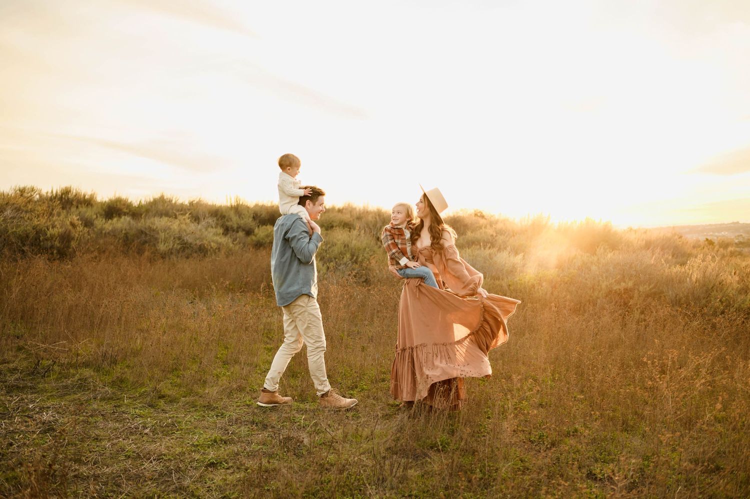 Ojai family photos by Ventura family photographer of family of four standing in grassy mountain field