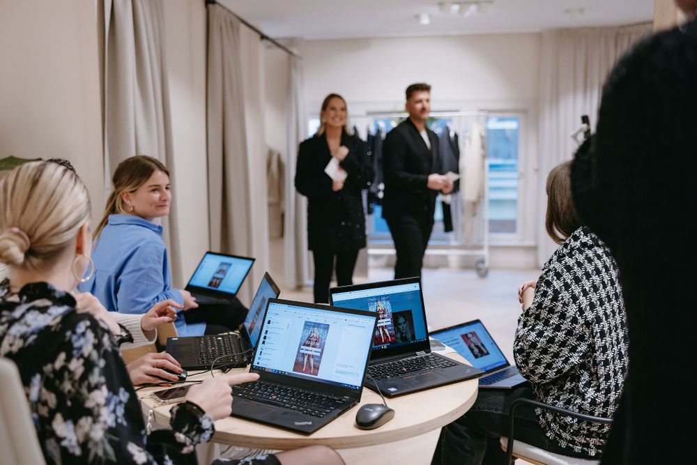 Business meeting with laptops and technology in a modern retail space.