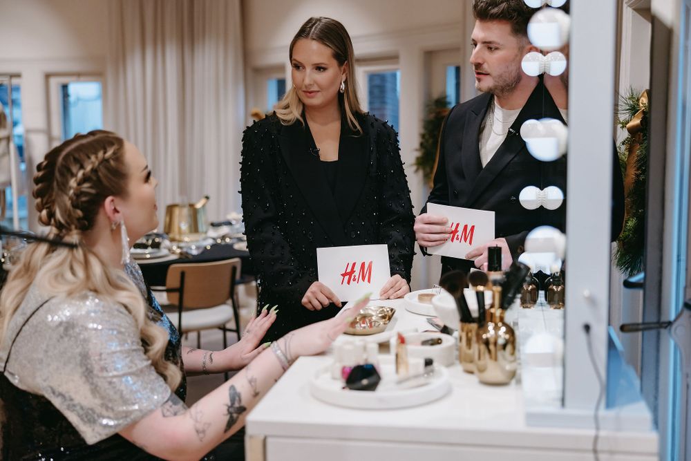 Retail consultation with H&M shopping bags at a vanity makeup station.