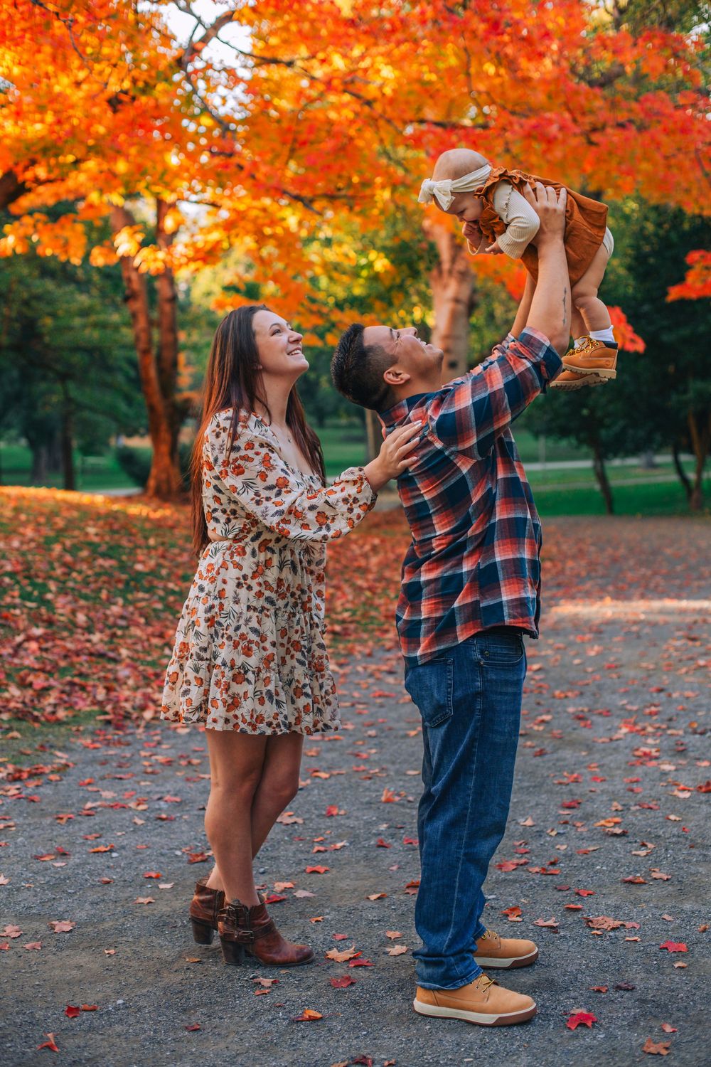 A playful family moment captured in a park with stunning fall foliage. Spokane Liberty Lake Photographer Family Photographer