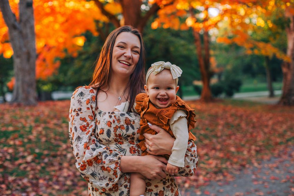 A joyful autumn scene with vibrant orange maple trees in the background. Spokane Liberty Lake Photographer Family Photographer