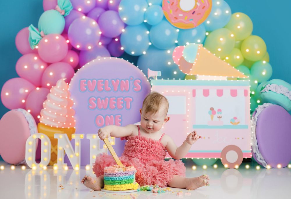 Colorful balloon arch decorates a dessert table with donuts and pink decor for a birthday celebration. goodna, redbank plains, belbird park