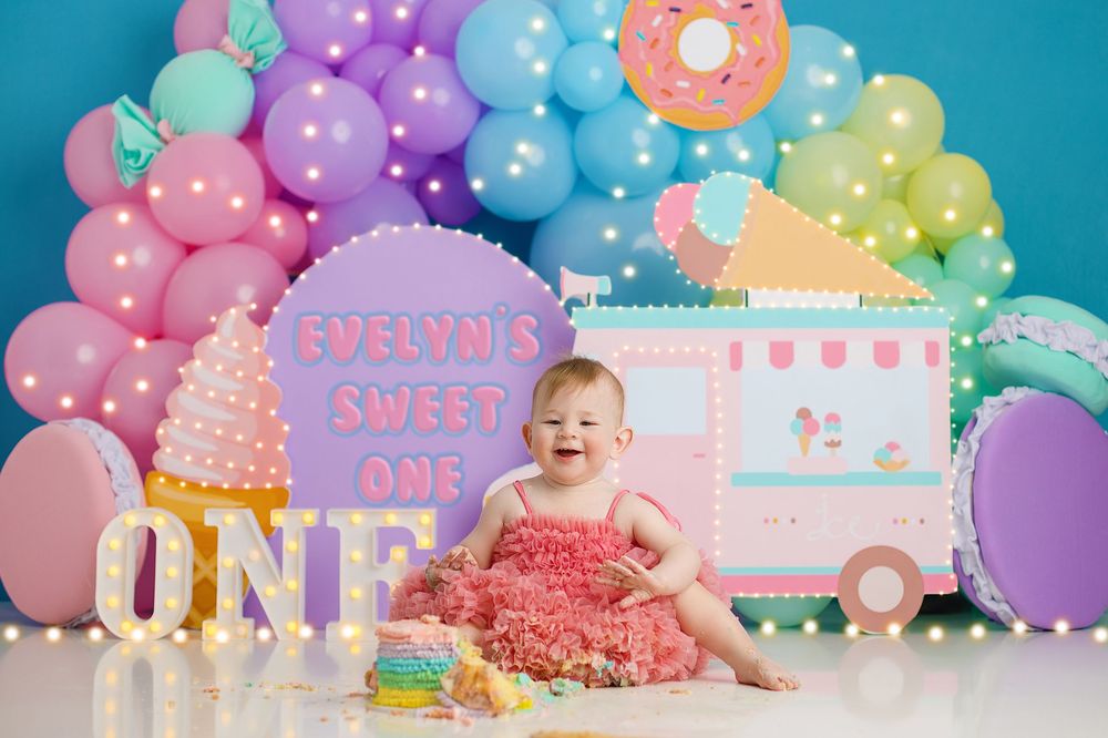 Sweet birthday celebration scene with pastel balloon garland and illuminated ONE sign. sweet one cake smash, springfield lakes, best cake