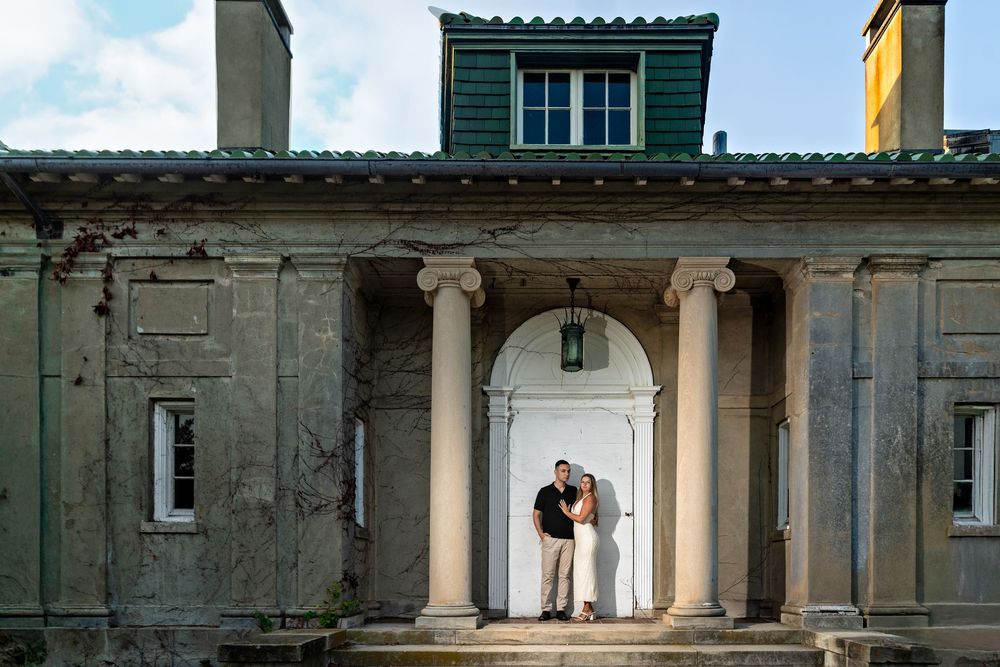 Elegant architectural columns and archways of a historic building facade at sunset.
