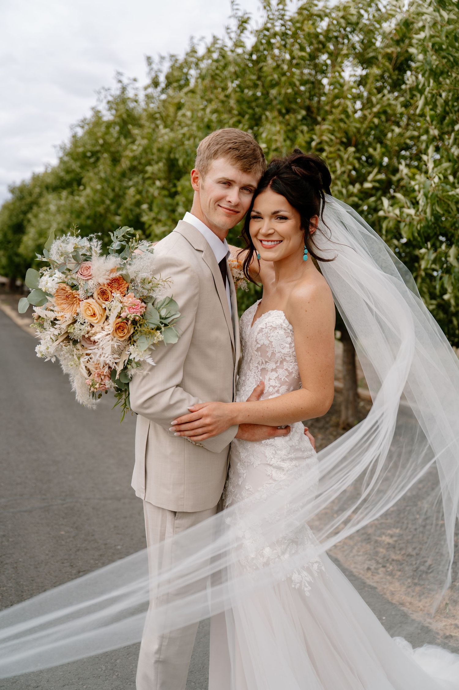 bride and groom under veil kissing on their wedding day