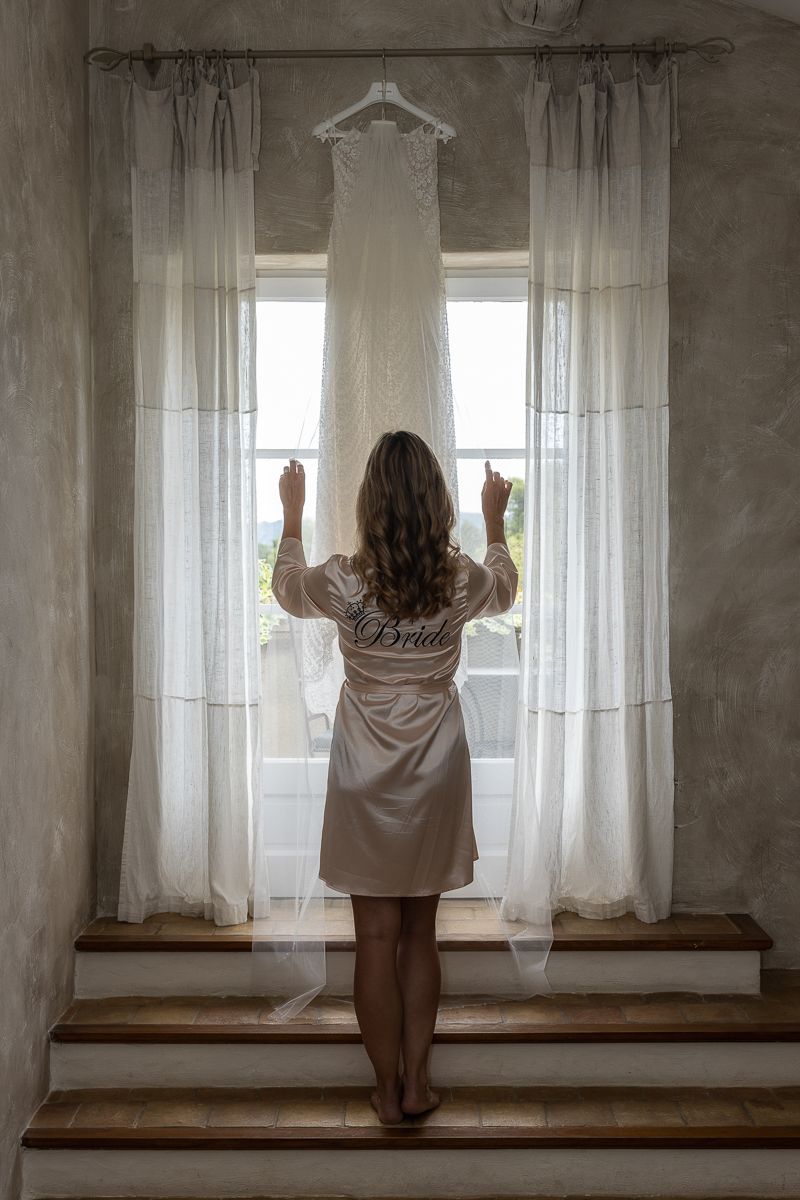 A sequence of photos shows someone opening white curtains in an empty room with concrete walls while standing on wooden bench.