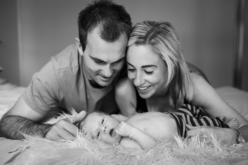 baby and happy parents looking on - Kelly Chapman Photographer Perth