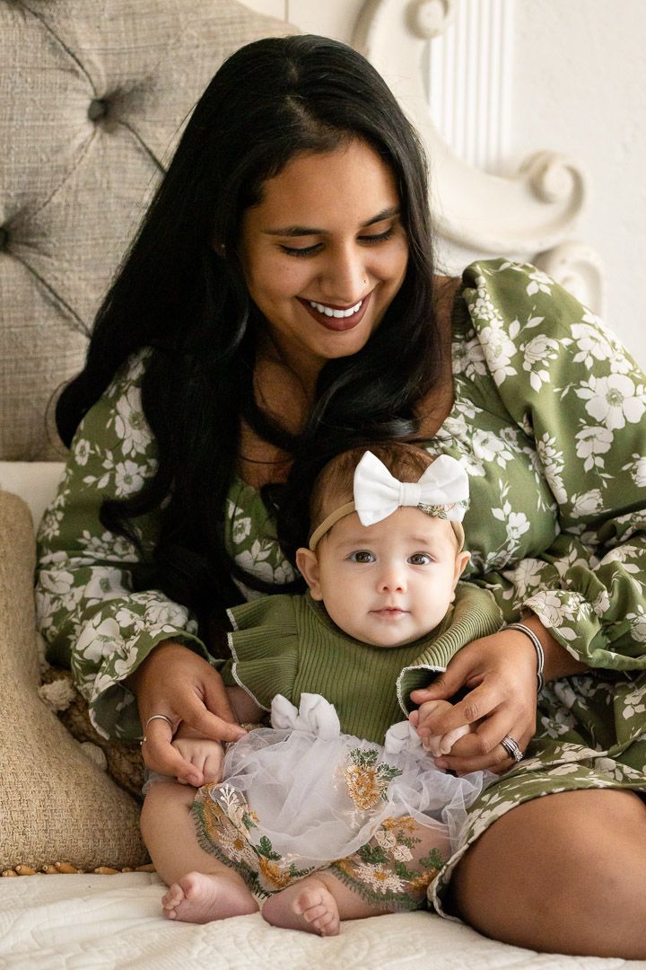 Mother in a green dress with her baby during a lifestyle studio session in Mountain Home, Arkansas